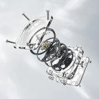 Exploded view of Agelocer transparent crystal square tourbillon watch showing case, dial rings and movement