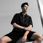 Male model wearing Agelocer transparent crystal tourbillon watch, seated studio lifestyle shot