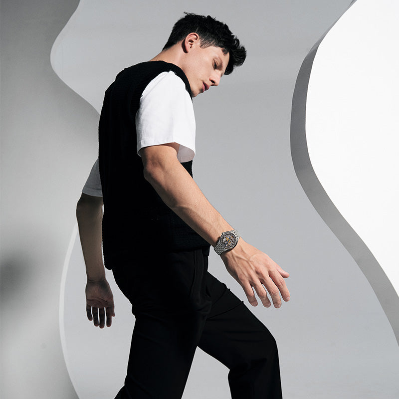Male model wearing Agelocer Schwarzwald double-sided skeleton automatic watch, studio lifestyle shot