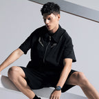 Male model wearing Agelocer free-sprung flying tourbillon watch, seated studio lifestyle shot