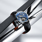 Agelocer flying tourbillon watch with blue skeleton dial resting on polished steel bars, lifestyle shot