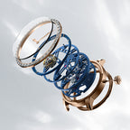 Exploded view of Agelocer free-sprung diamond tourbillon watch showing rose gold case, diamond bezel and movement