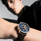 Man wearing Agelocer free-sprung diamond tourbillon watch, rose gold case and blue dial, wrist lifestyle view