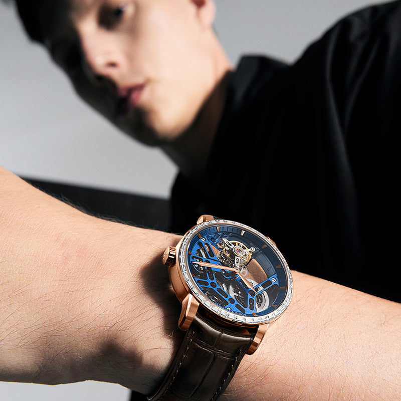 Man wearing Agelocer free-sprung diamond tourbillon watch, rose gold case and blue dial, wrist lifestyle view