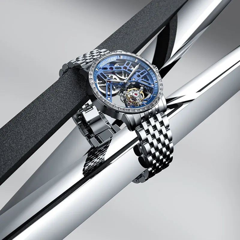 Agelocer Free-Sprung diamond tourbillon watch with blue dial and steel case displayed at an angle, showcase