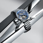 Agelocer Free-Sprung diamond tourbillon watch with blue dial and steel case displayed at an angle, showcase