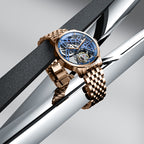 Agelocer Free-Sprung skeleton tourbillon watch with blue dial and rose gold case displayed at an angle, showcase