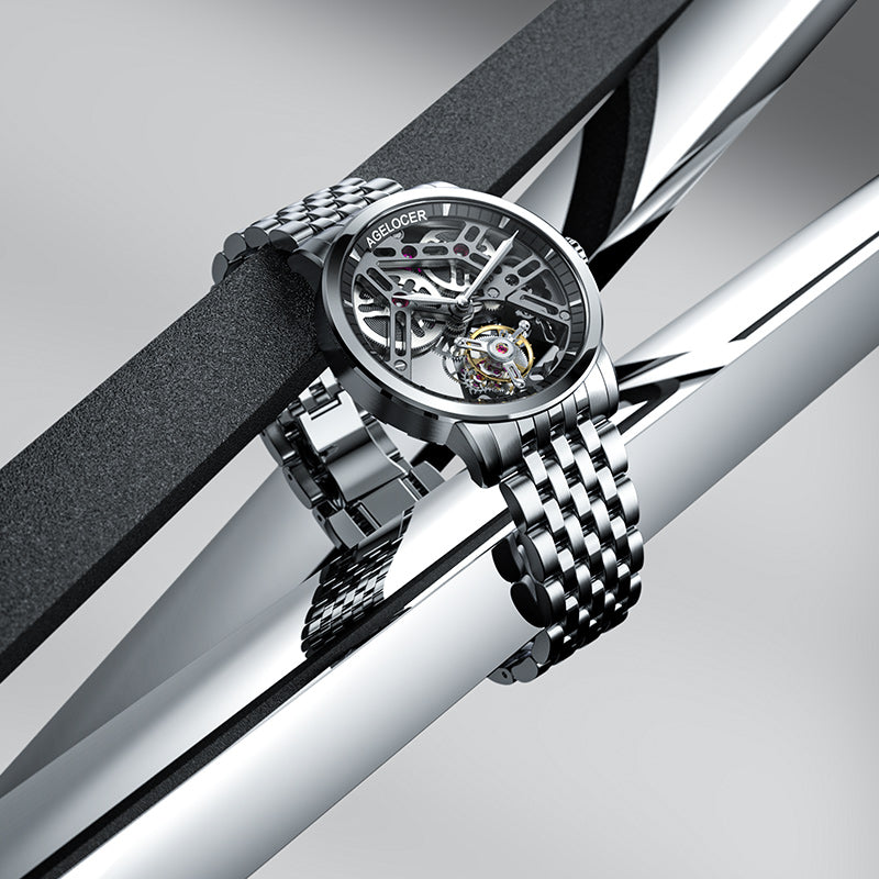 Agelocer flying tourbillon watch with steel bracelet resting on polished steel bars, lifestyle shot