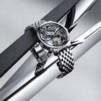 Agelocer flying tourbillon watch with steel bracelet resting on polished steel bars, lifestyle shot