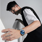Agelocer Galaxy Astronomer on a male model's wrist, steel bracelet moon phase watch in a studio pose