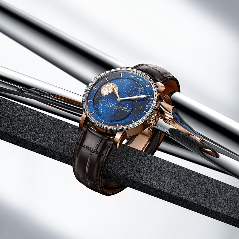 Agelocer Astronomer Galaxy rose gold moonphase watch staged on polished steel bars