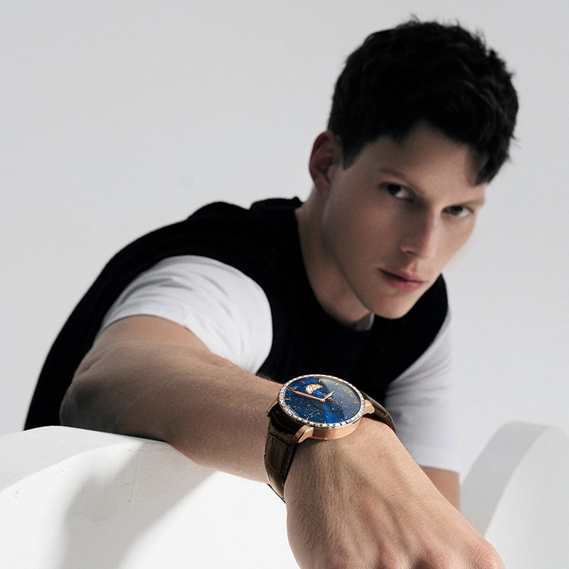Male model wearing Agelocer Astronomer galaxy moonphase diamond watch with rose gold case, lifestyle shot