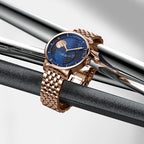 Agelocer galaxy rose gold moon phase watch displayed on polished metal bars, product shot