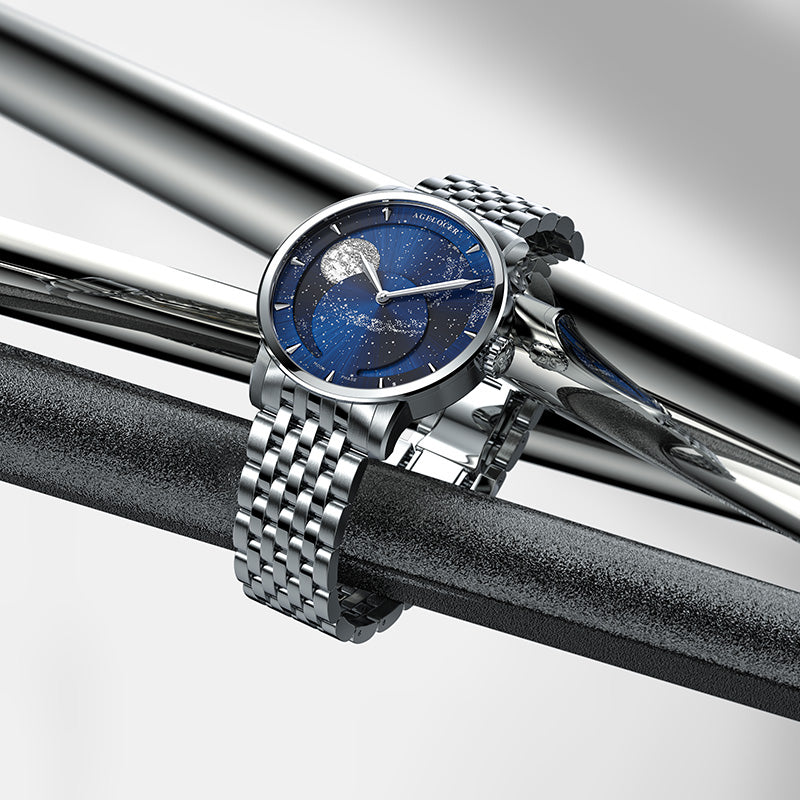 Agelocer Astronomer galaxy moonphase watch with steel bracelet resting on polished steel bars, lifestyle shot