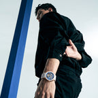 Male model wearing Agelocer hollow tourbillon watch with white rubber strap, dynamic studio lifestyle shot