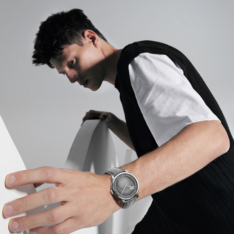 Male model wearing Agelocer Astronomer moonphase watch, studio lifestyle shot