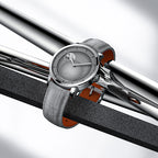 Agelocer Astronomer moonphase watch with steel case and grey strap resting on polished steel bars, lifestyle