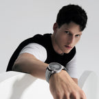 Man wearing Agelocer Astronomer moonphase automatic watch with grey dial on grey strap, wrist view