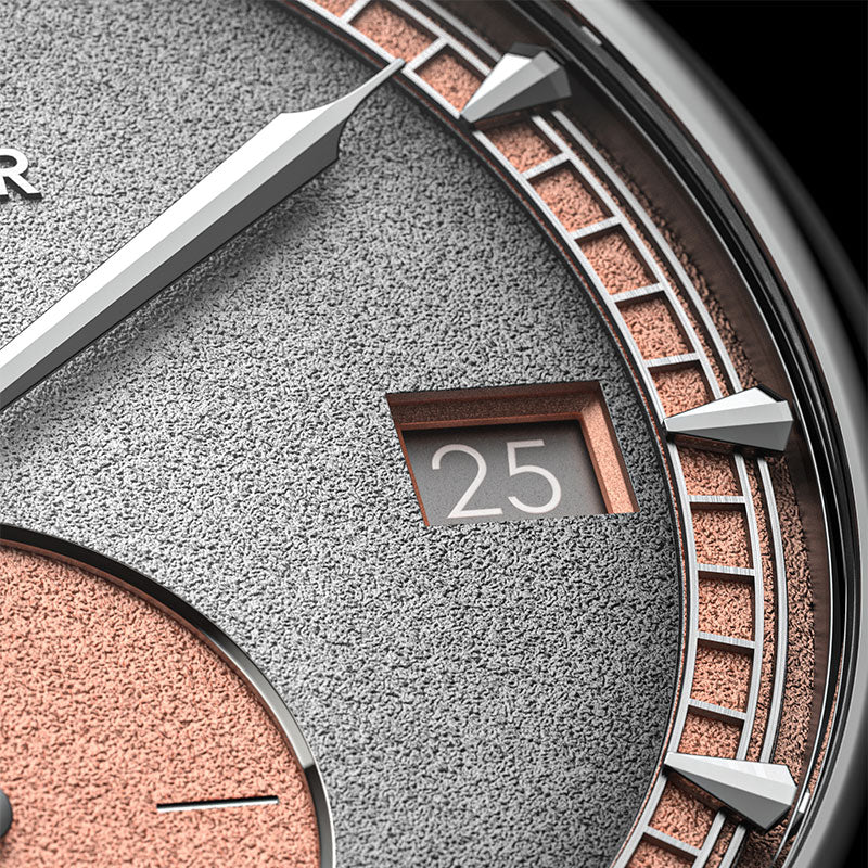 Macro of Agelocer Petite Seconde grey dial showing framed date window and salmon minute track