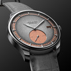 Agelocer Petite Seconde automatic watch angled close-up, steel case with salmon sub-dial and grey dial