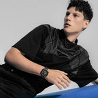 Male model wearing Agelocer Racing Fast & Furious steel-bracelet watch, seated studio lifestyle shot