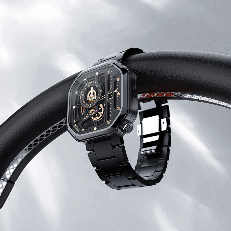 Agelocer Racing Fast & Furious black steel watch resting on a car steering wheel, racing lifestyle shot