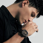 Man wearing Agelocer Racing Hollow black square skeleton watch on black leather strap, lifestyle portrait