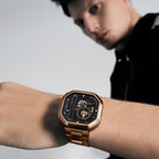 Man wearing Agelocer Racing Square rose gold automatic skeleton watch on steel bracelet, wrist lifestyle