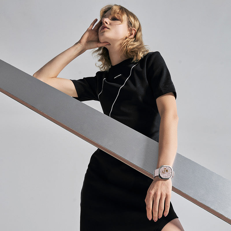 Woman wearing Agelocer Racing pink square automatic watch, studio lifestyle portrait