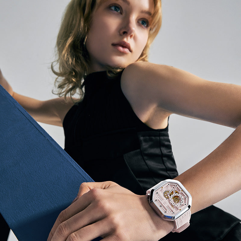 Woman posing with Agelocer Racing pink square automatic watch on the wrist, lifestyle shot