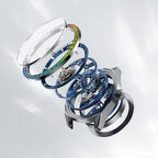 Exploded view of Agelocer rainbow bezel tourbillon watch showing crystal, gem-set bezel and skeleton movement