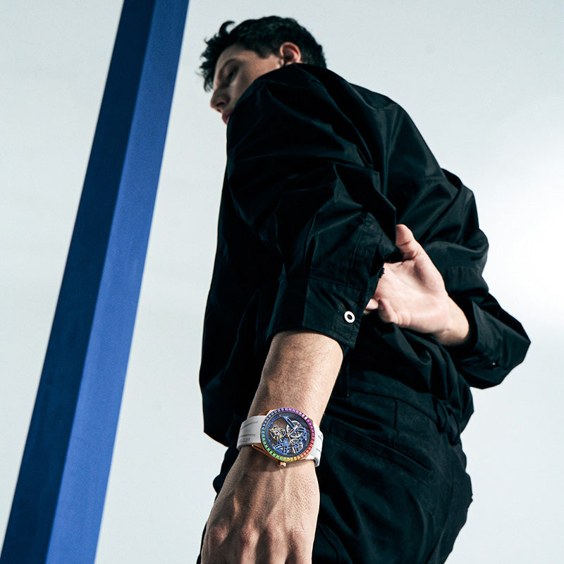 Man walking wearing Agelocer rainbow tourbillon watch on white rubber strap, lifestyle shot