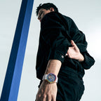 Man walking wearing Agelocer rainbow tourbillon watch on white rubber strap, lifestyle shot