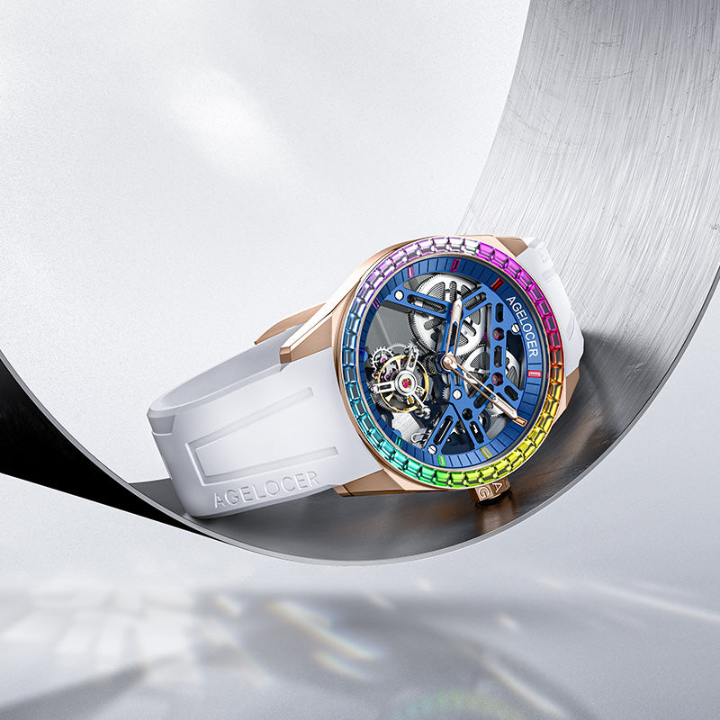 Agelocer rainbow tourbillon rose gold watch on a curved metal surface, product shot