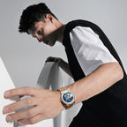 Male model wearing Agelocer Astronomer painted moonphase watch on a rose gold bracelet, wrist lifestyle shot