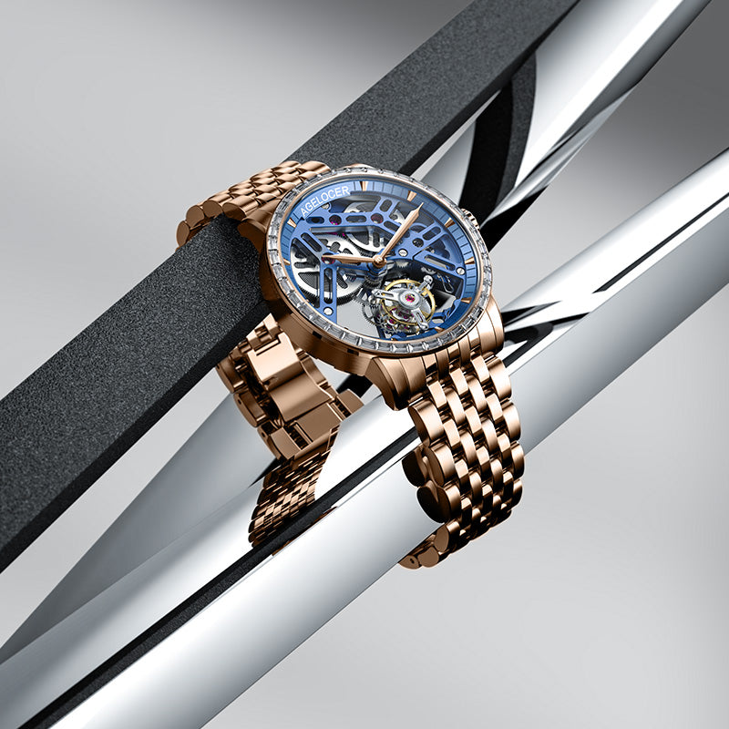 Agelocer diamond tourbillon rose gold watch displayed on polished metal bars, product shot
