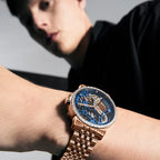 Man wearing Agelocer diamond tourbillon rose gold skeleton watch on bracelet, wrist shot