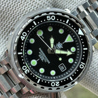Angled close-up of the STEELDIVE SD1975K black dial with lumed hands and date window