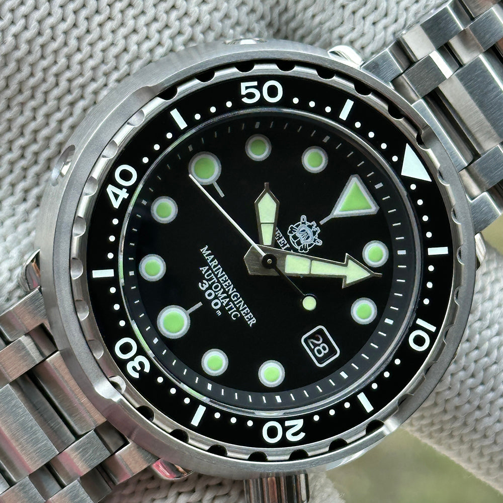 Angled close-up of the STEELDIVE SD1975K black dial with lumed hands and date window
