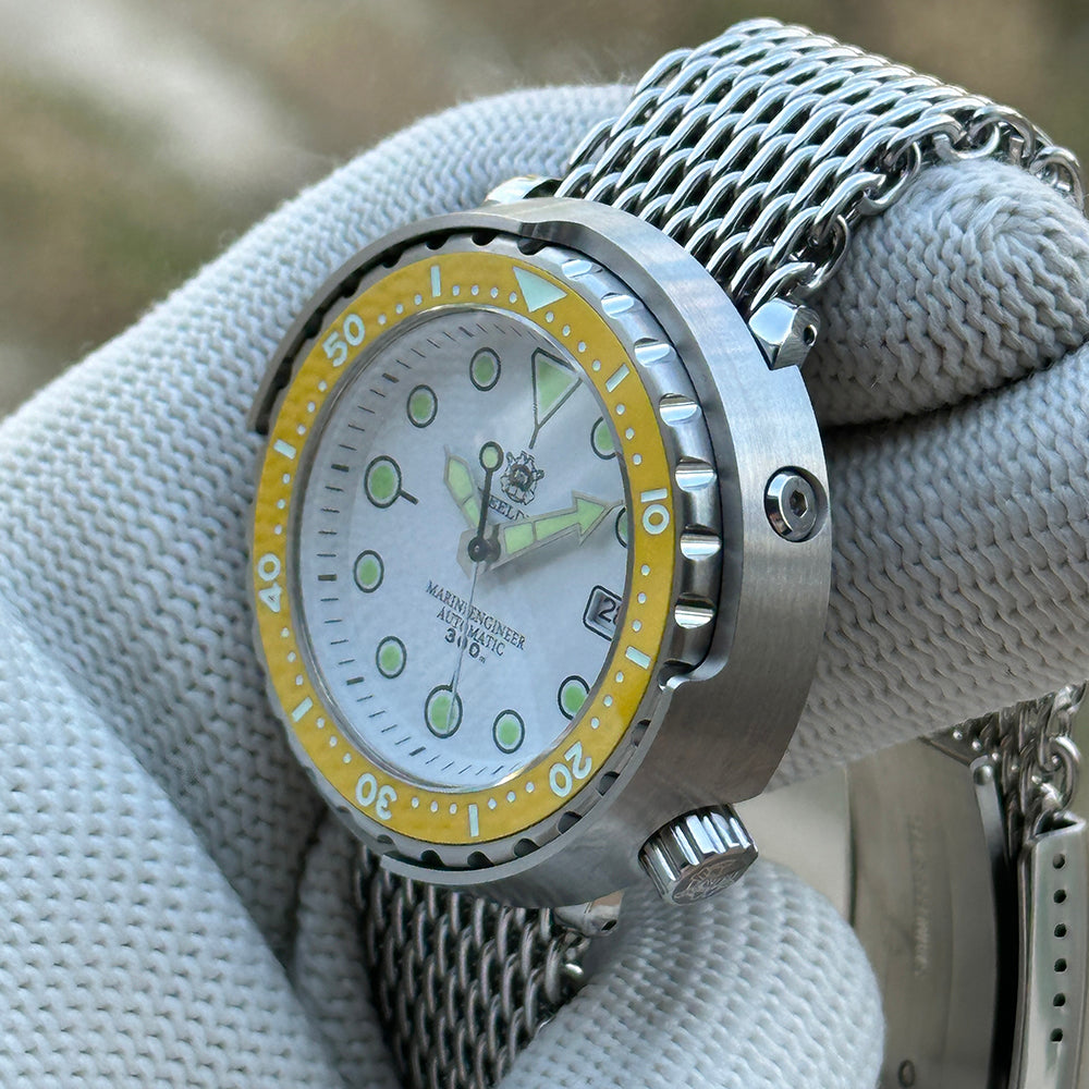 Angled view of the STEELDIVE SD1975N yellow bezel version on a steel mesh bracelet