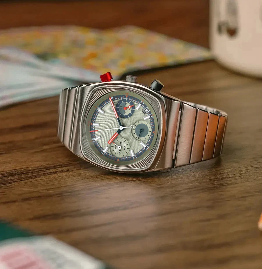 Ciloa retro chronograph with grey dial and blue subdial on wood table styled with mug