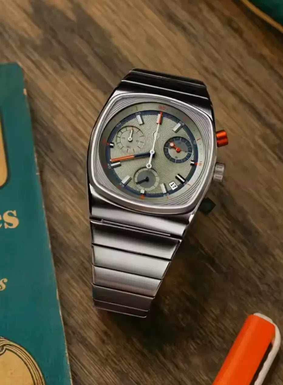 Ciloa retro chronograph with grey dial on wood table styled beside teal vintage book