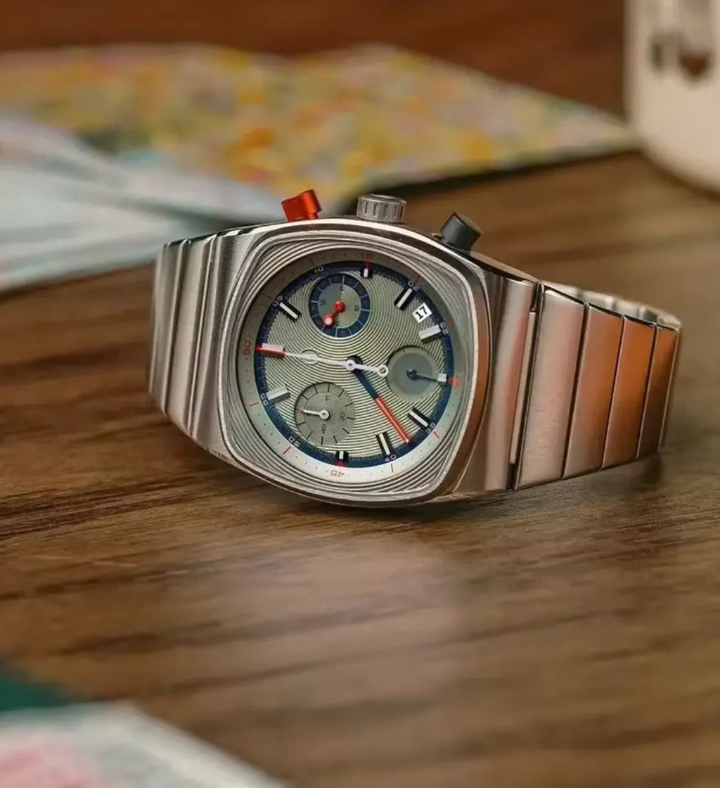 Ciloa retro chronograph watch with grey dial on wood beside floral fabric and mug