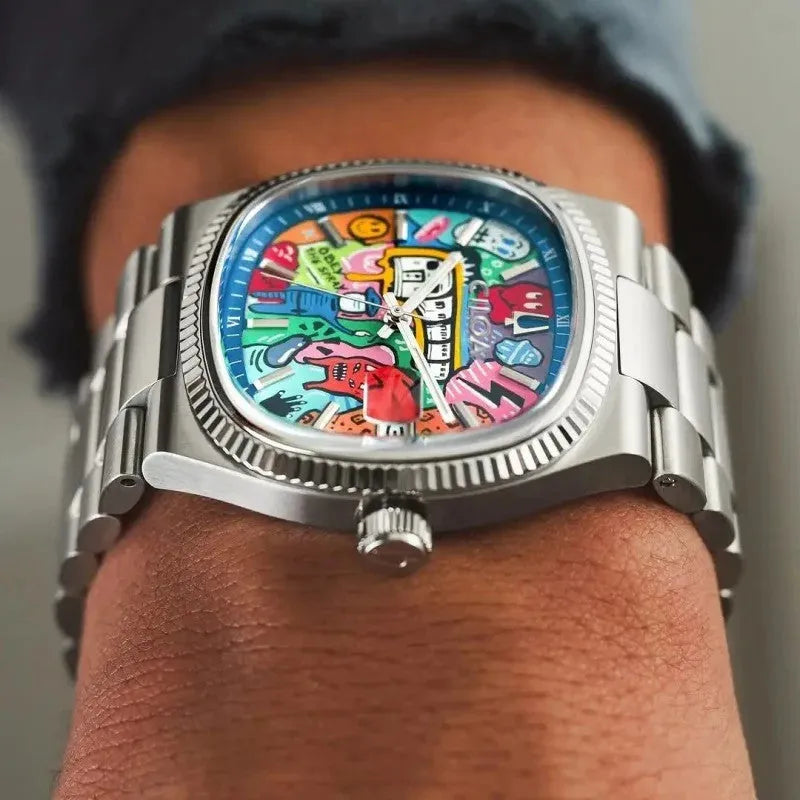 Ciloa painted dial watch worn on wrist with navy sweater showing graffiti dial