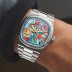 Ciloa painted dial watch with graffiti dial worn on wrist with navy sleeve