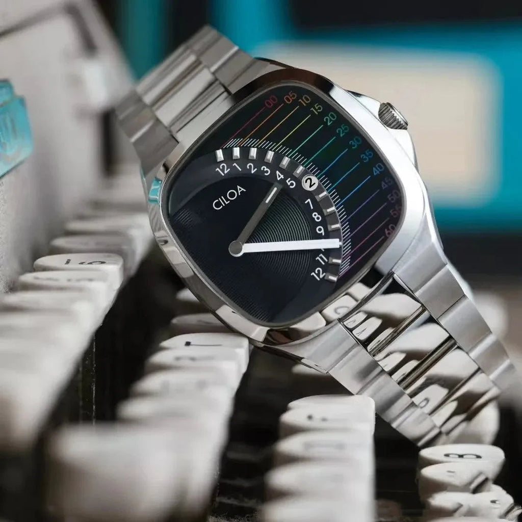 CILOA retro square quartz with black dial and rainbow scale resting on vintage typewriter