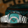CILOA retro square quartz watch with teal half-disc dial styled beside patterned teal prop