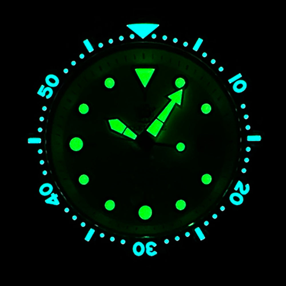 Close-up lume shot of the STEELDIVE SD1975N dial and bezel glowing in the dark