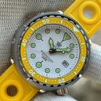 Close-up of the STEELDIVE SD1975N white dial with yellow bezel on a yellow rubber strap