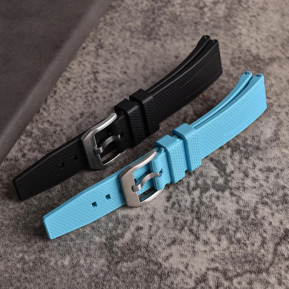 Fluororubber watch straps in black and sky blue showing silver pin buckle clasp detail